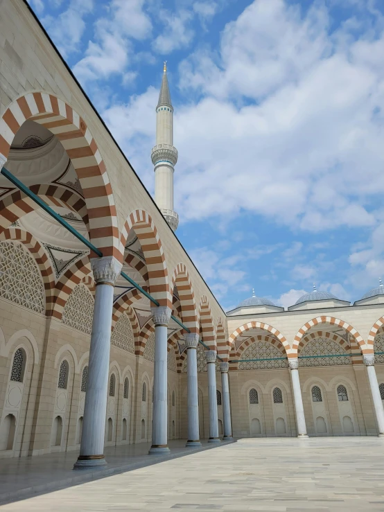 a long building with a white and red pillars