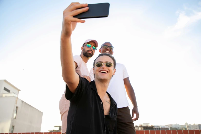 a man takes a po with his friends while taking a po