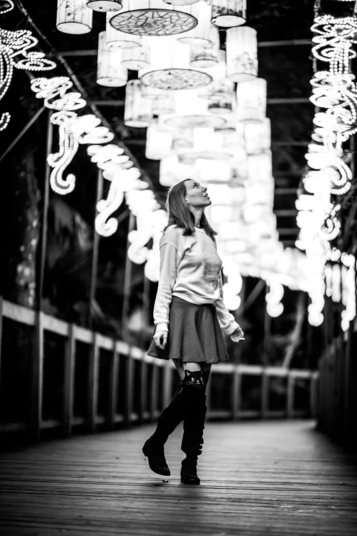 woman standing alone near lights in the dark