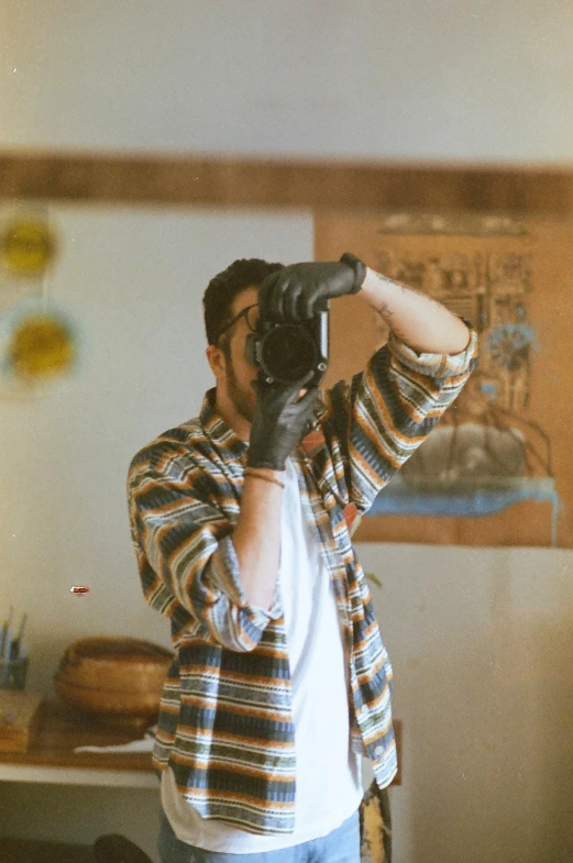 man taking po in living room with camera