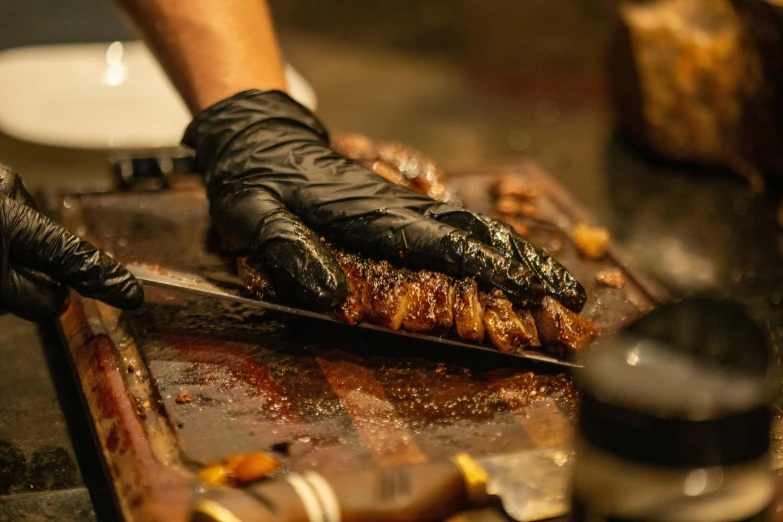 an old pair of gloves is being pulled over some meat