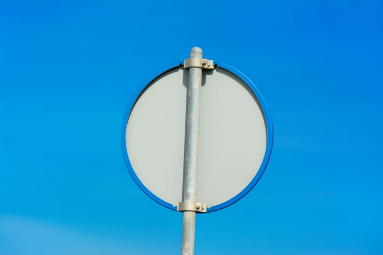 a white and blue sign is on a pole