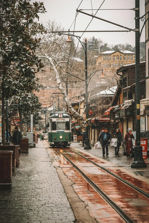 an image of a trolley on tracks running down the street