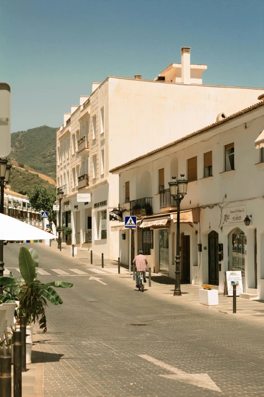 some people are on a street by several buildings