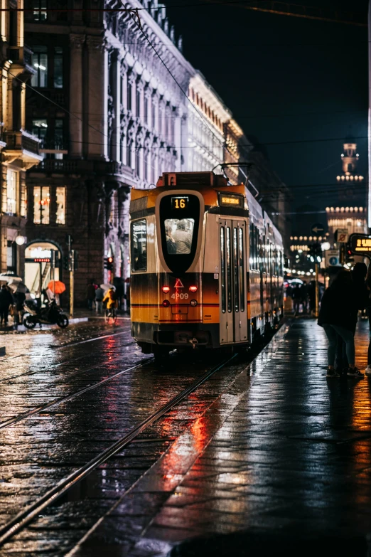 a public transit bus driving through a city at night