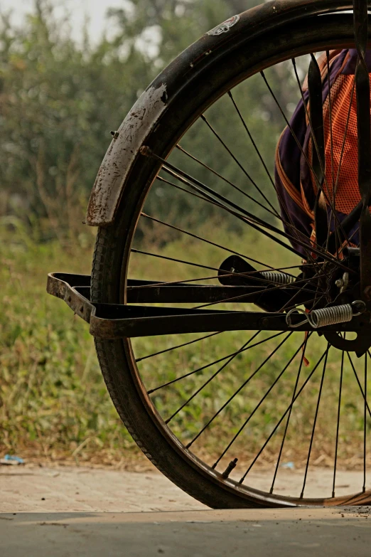 someone sitting on the back of a bike outside