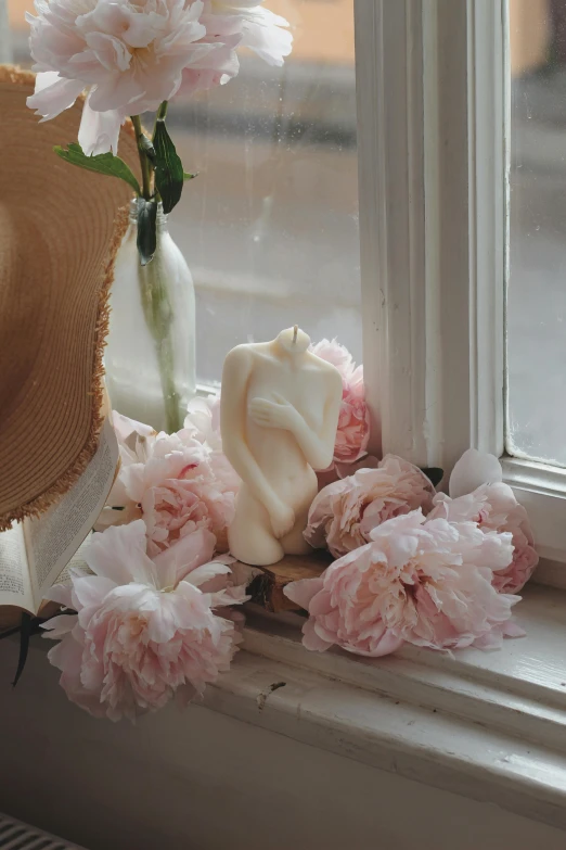 flowers are sitting on the windowsill near a glass vase