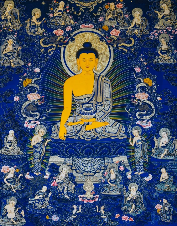 buddha seated in the middle of a blue carpet