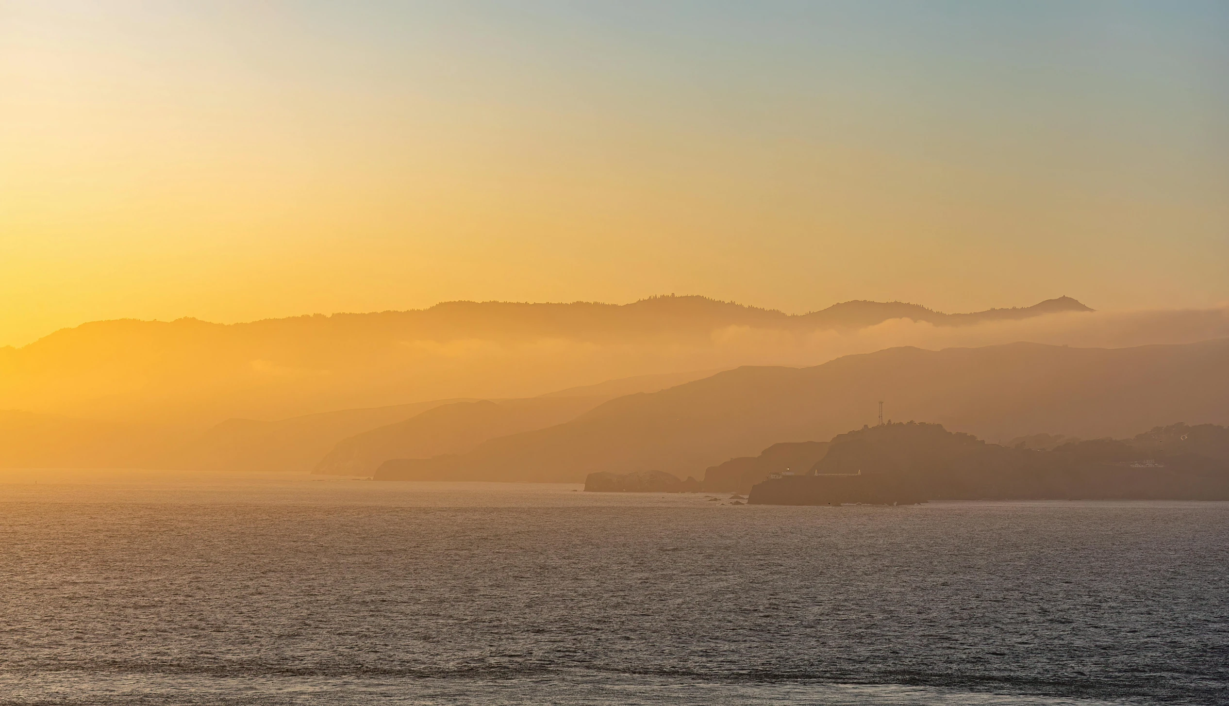 a boat traveling on the water at sunset