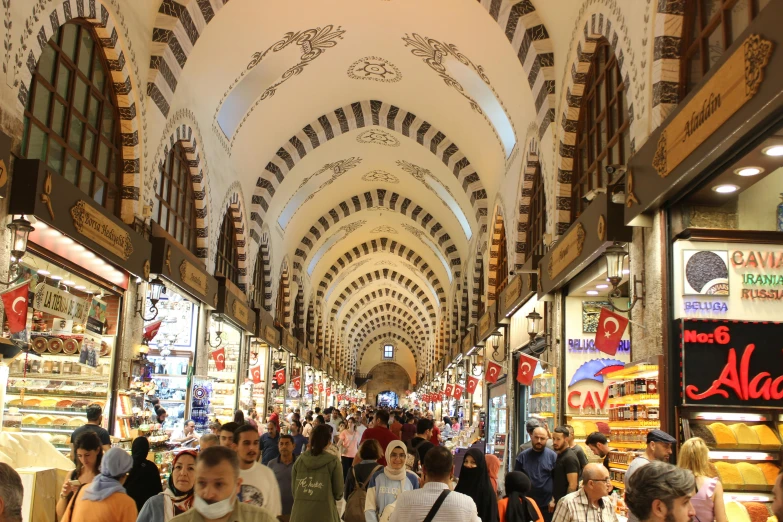 a big crowd is walking through the mall