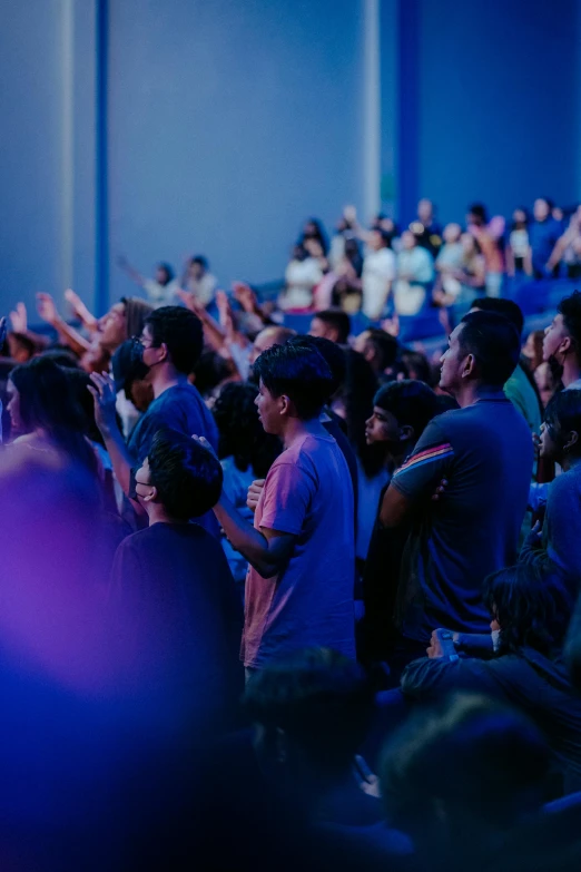 a crowd of people at an audience in a large room