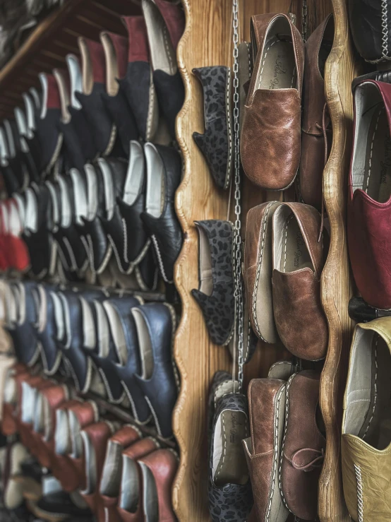 there are many different shoes that are hanging on the wall