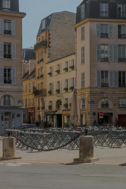 a building sits between other buildings and has a balcony