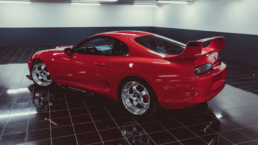 a red sports car is shown with its tail lights on