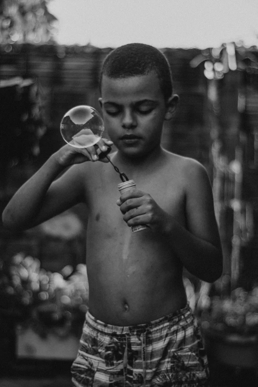 a boy with  is holding a magnifying glass