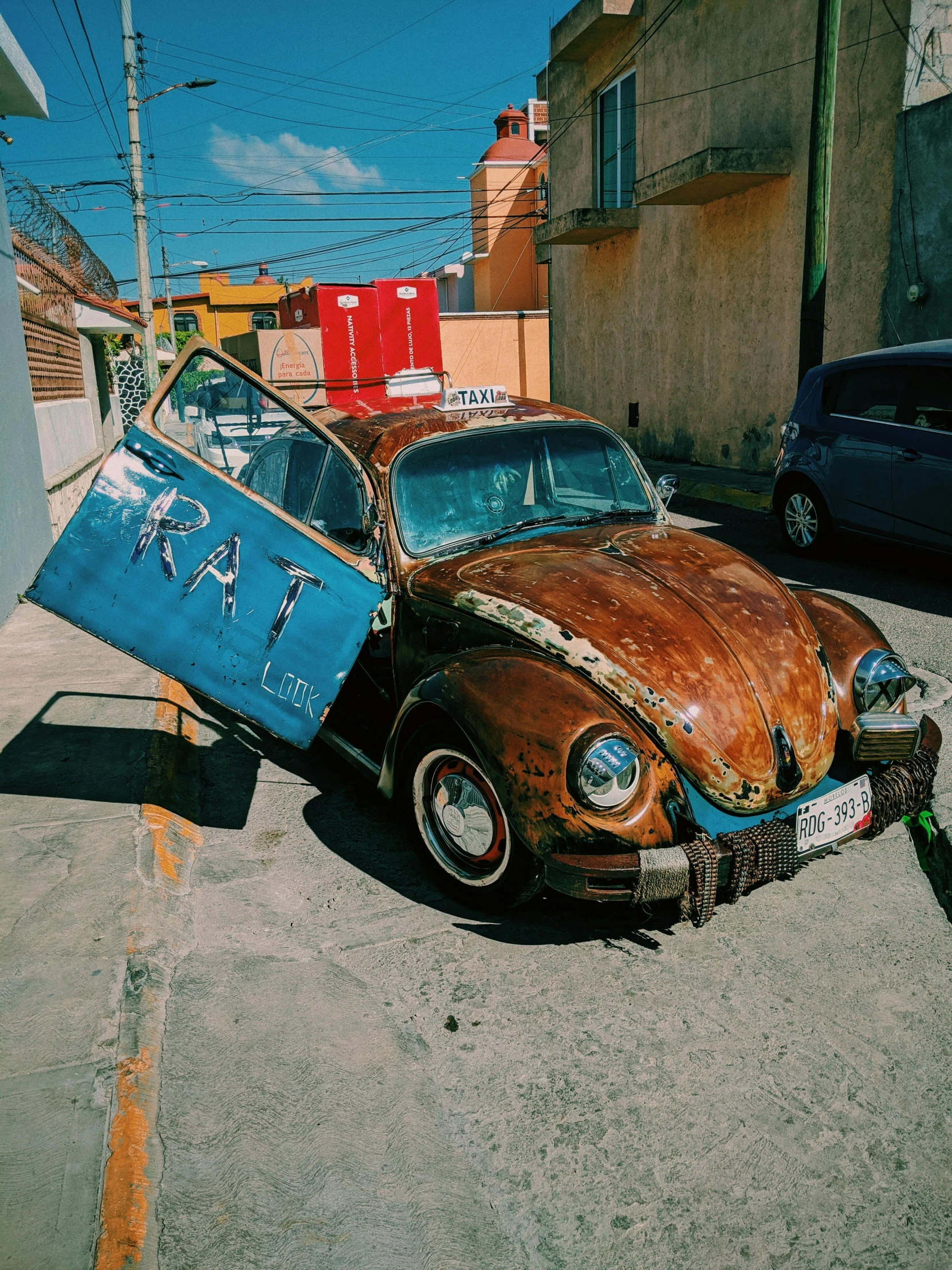 the old rusty car is being driven by another car