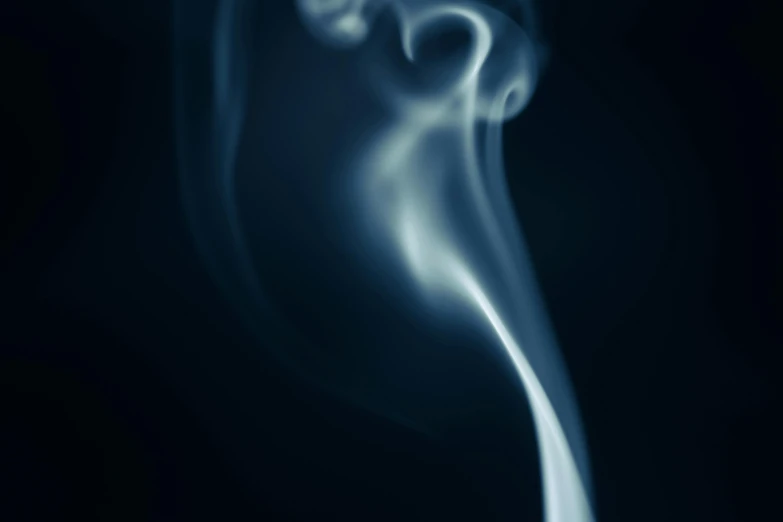 some smoke is swirling over a black background