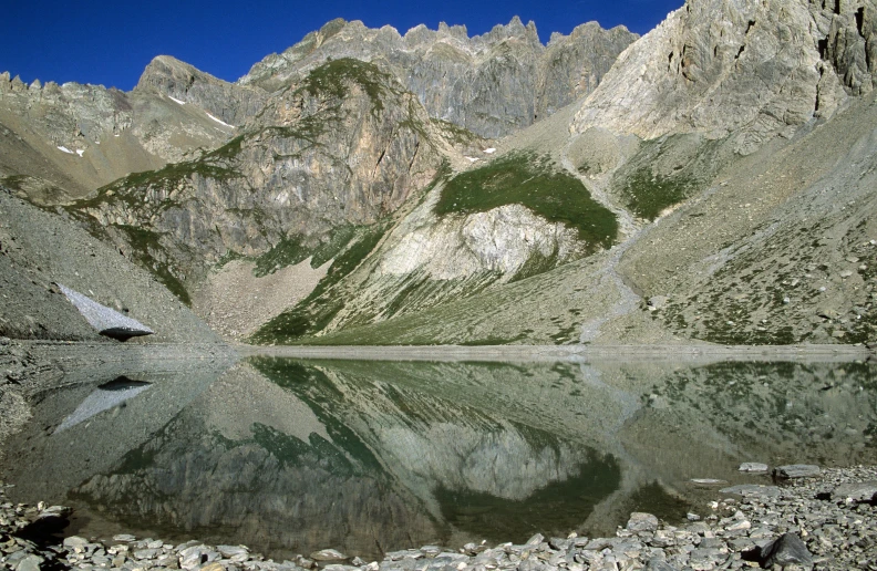 a view of a mountain range and a lake that is reflecting the sky