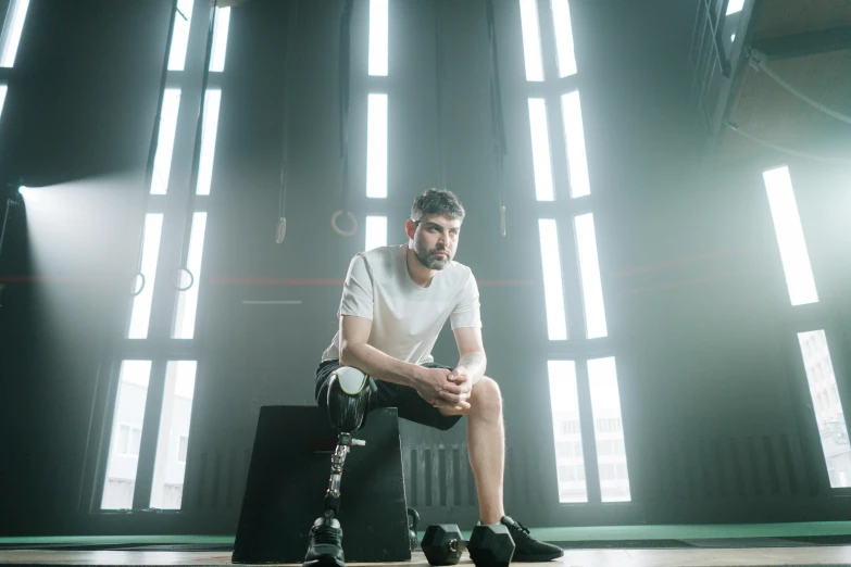 a man sits on a suitcase in the dark room