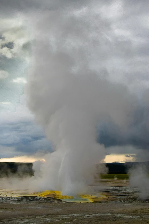 the geyser rises into the air as the sun is shining