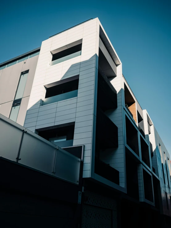 a building with balconies and a metal gate in front of it