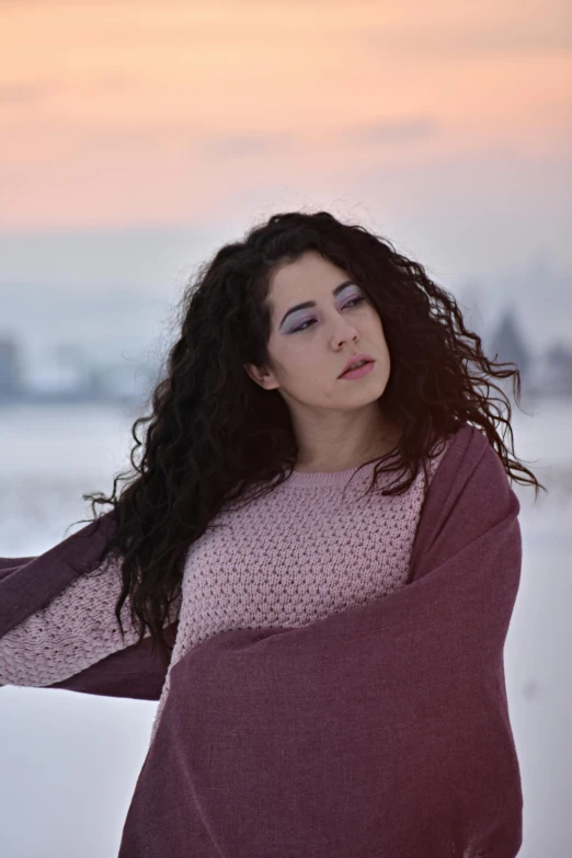 a woman with long black hair wearing a red sweater