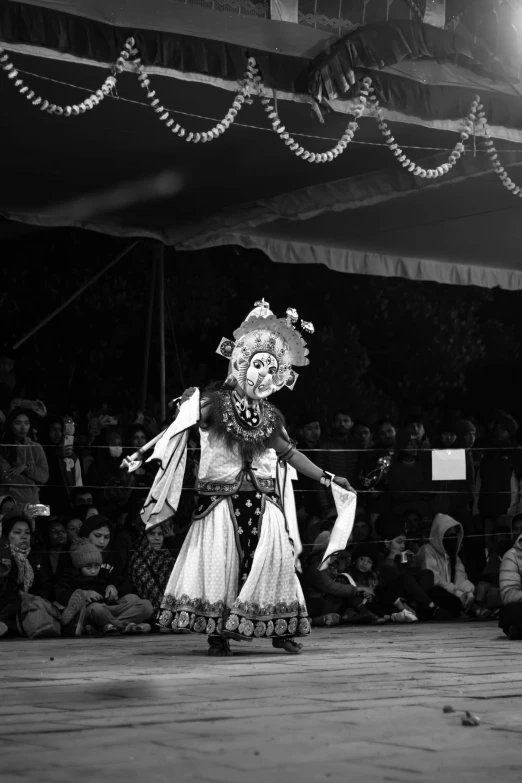 two people dressed in costume are on a stage