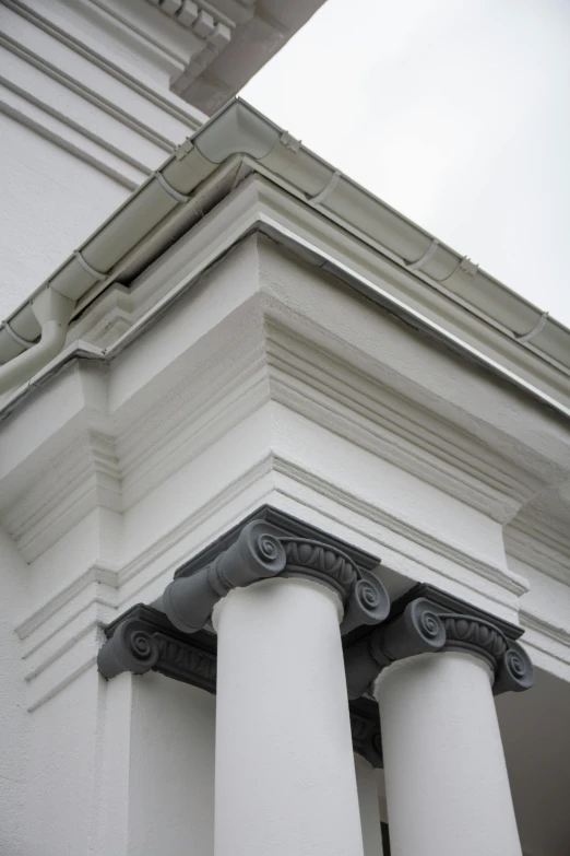 a column between two white building faces