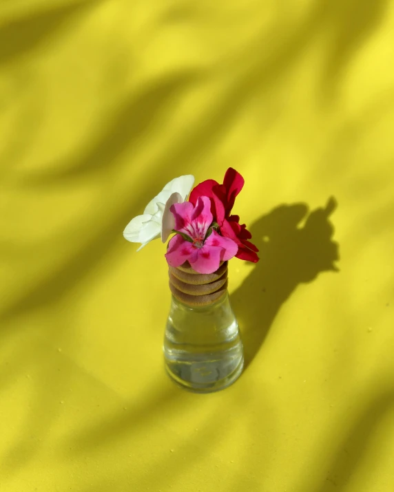 a vase sitting on top of a yellow cloth