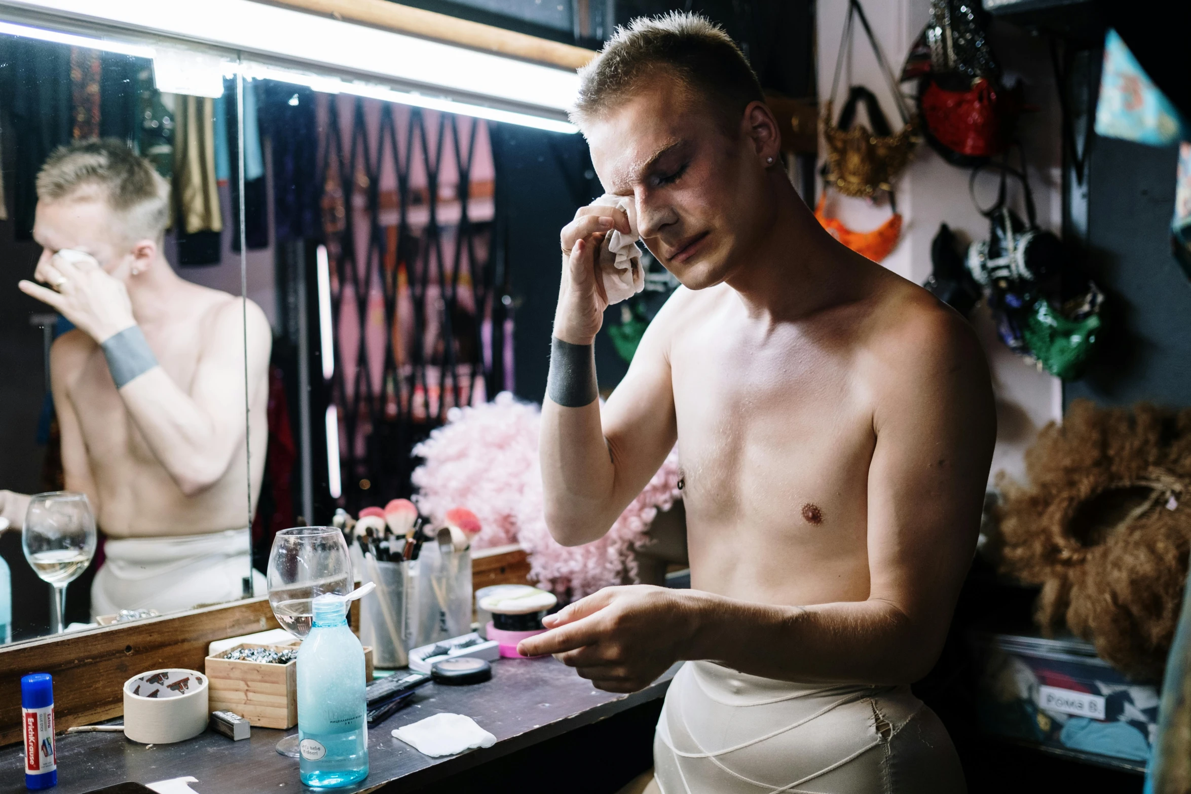 a person standing in front of a mirror talking on a cell phone