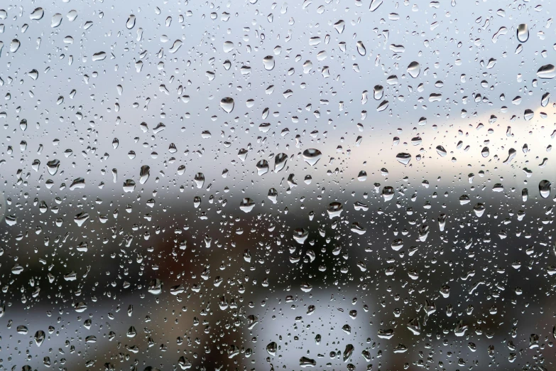 the outside view of buildings, from outside a rain covered window