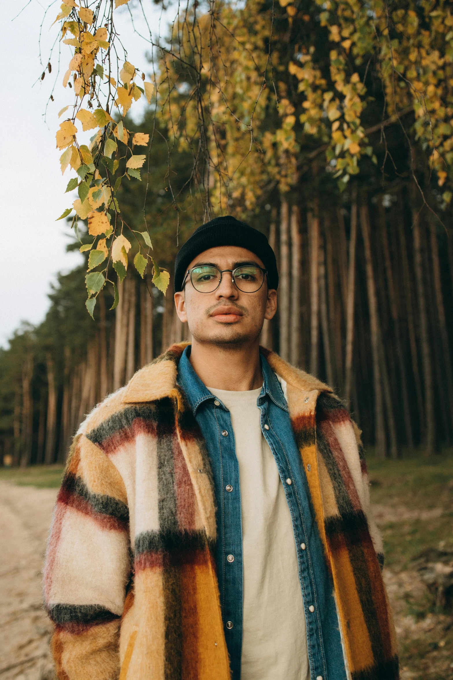 a man standing in front of a forest