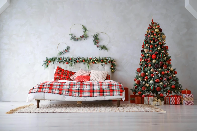 a decorated bedroom with a christmas tree and couch in the foreground