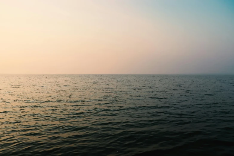 a body of water with the sky in the background