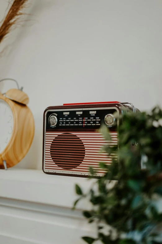 an old radio sitting on top of a fireplace mantle next to a clock