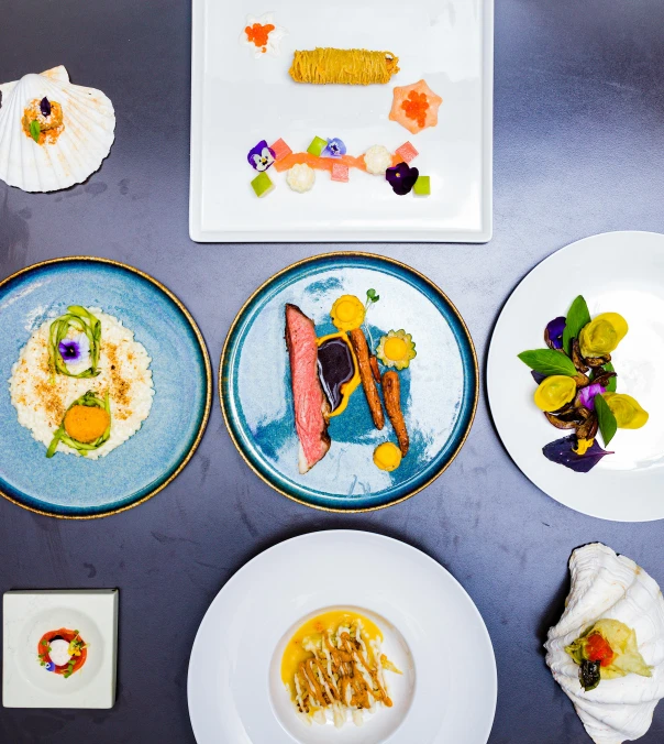 several different plates sit on a table that have a name on them