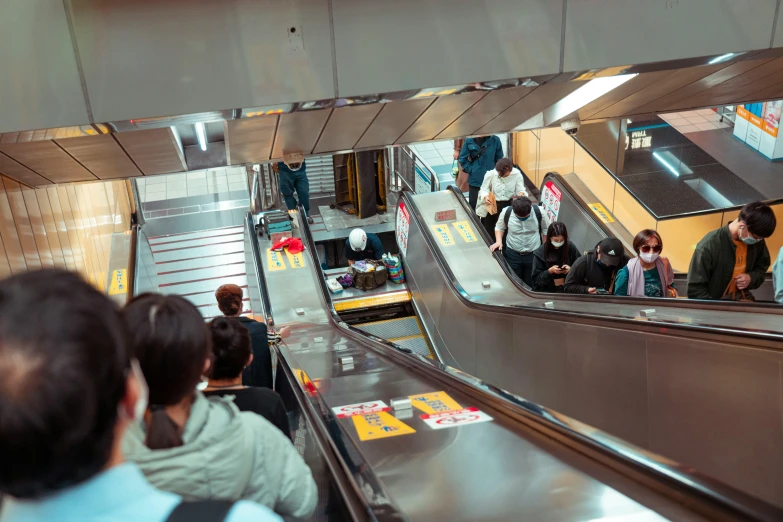 people on escalators at an empty subway