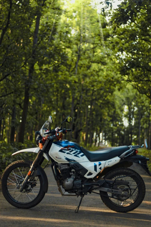 a blue and white motorcycle sitting on the street