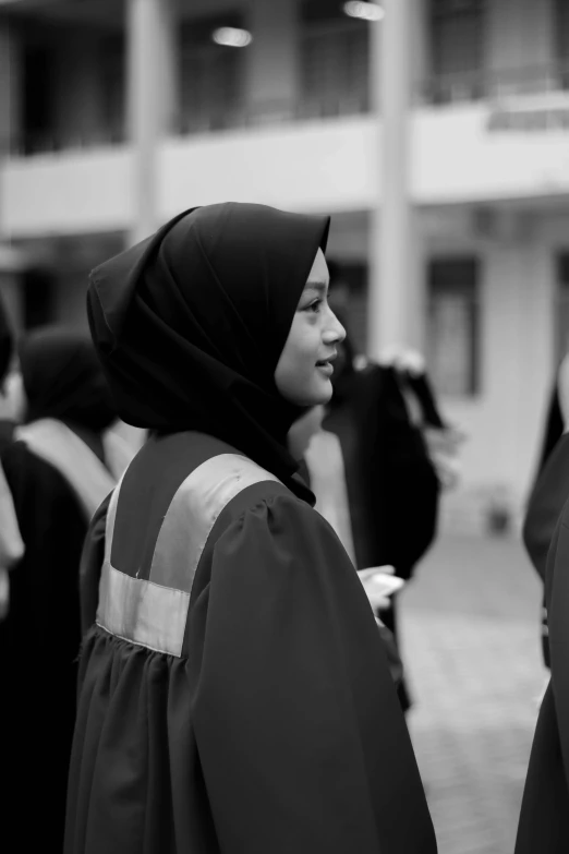 people wearing hijabs walking near a building