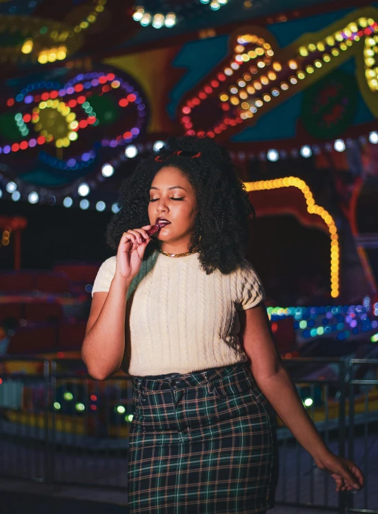 a woman is standing in front of colorful lights