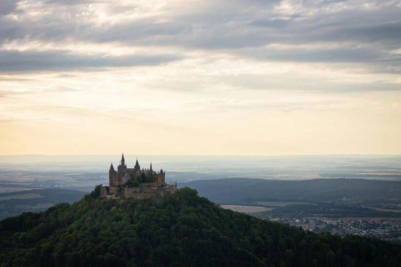 the castle is perched on top of a tall hill