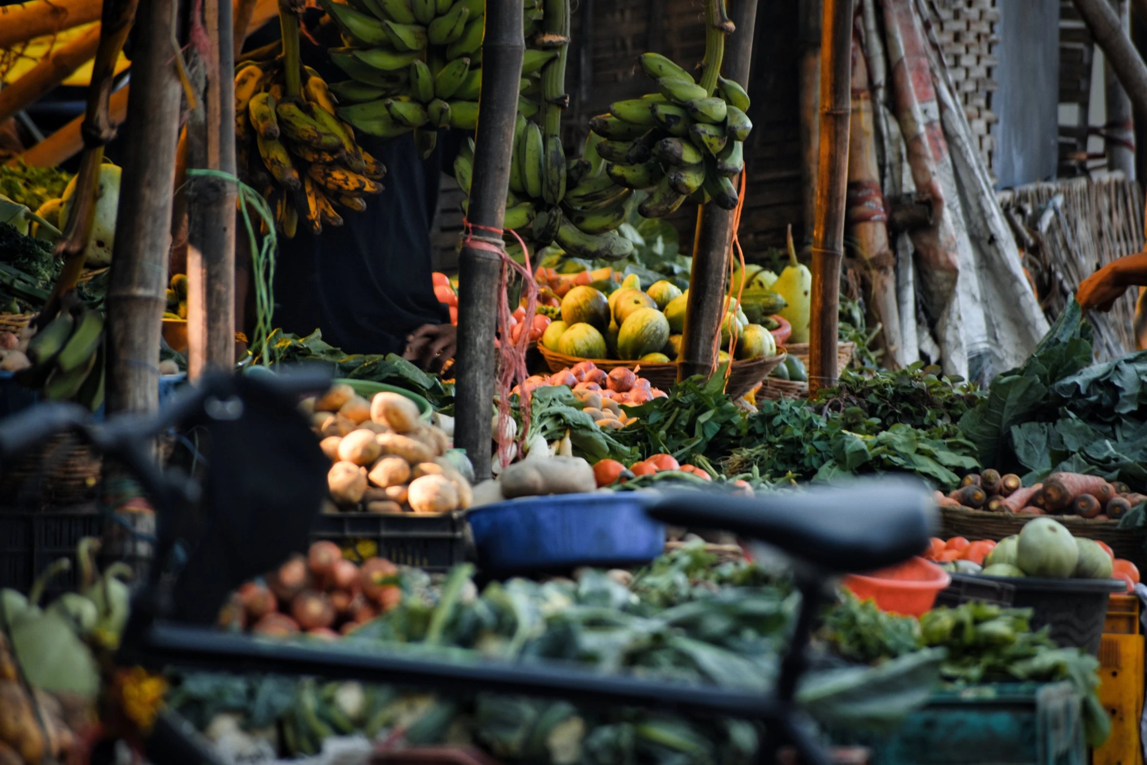 an open market with several fruits and vegetables