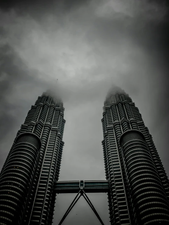 a pair of tall buildings are shown in the sky