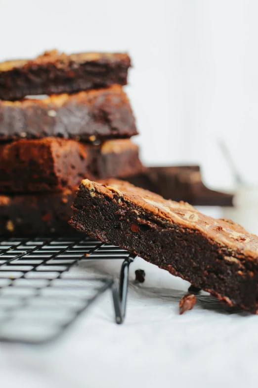 brownies sitting on a cooling rack next to some chocolate chips