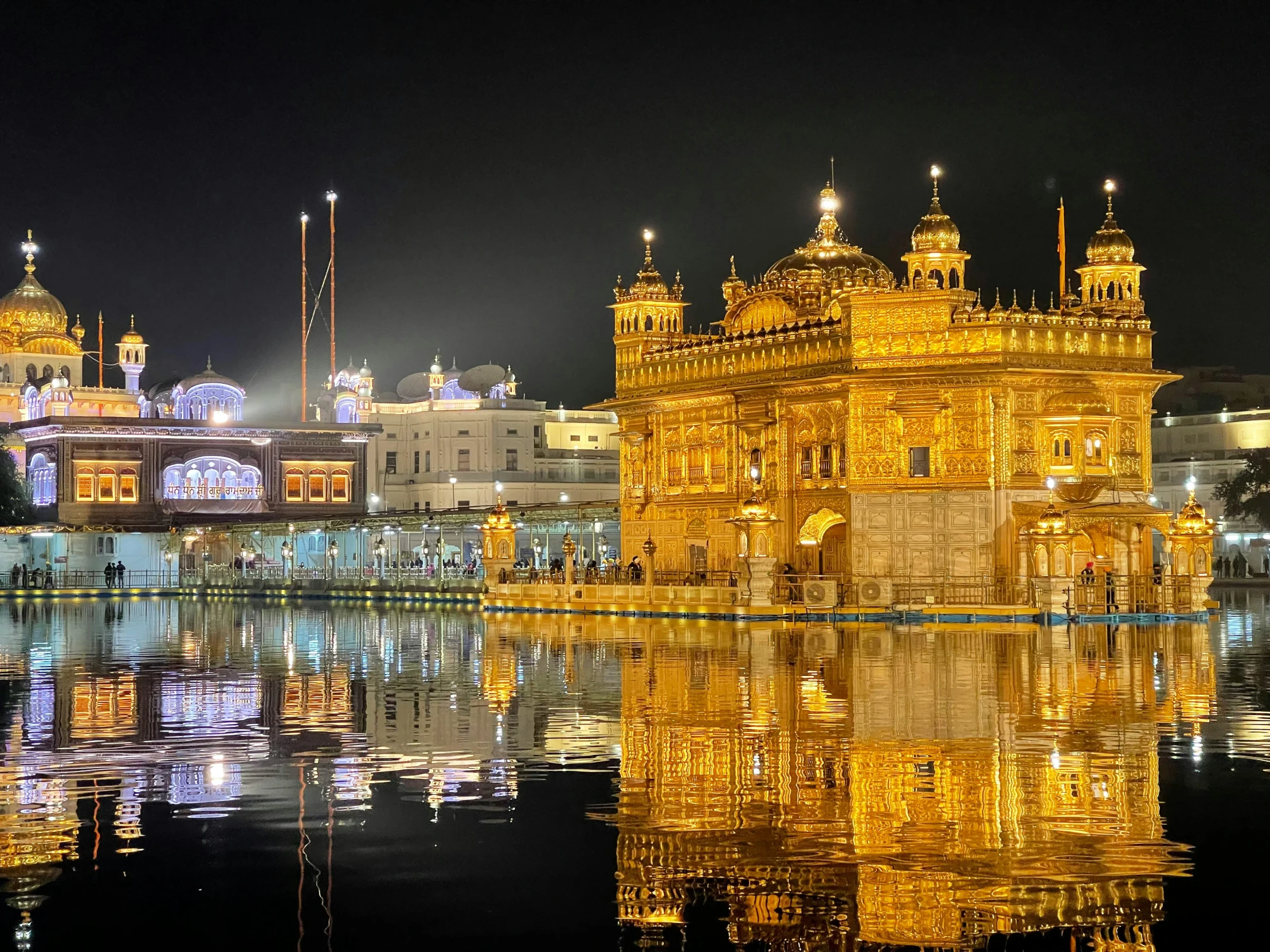 the lights of a building reflect in water