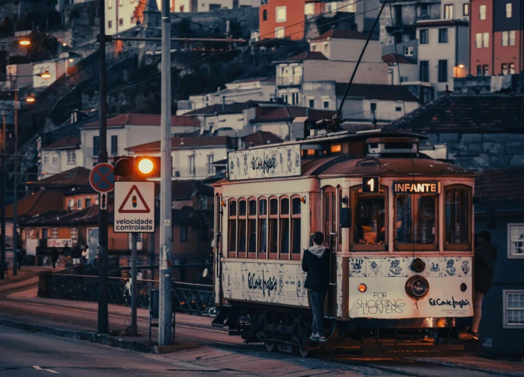 a train with graffiti passing through a city street