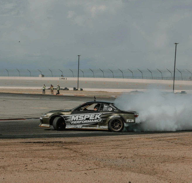 a race car with smoke coming out the exhaust