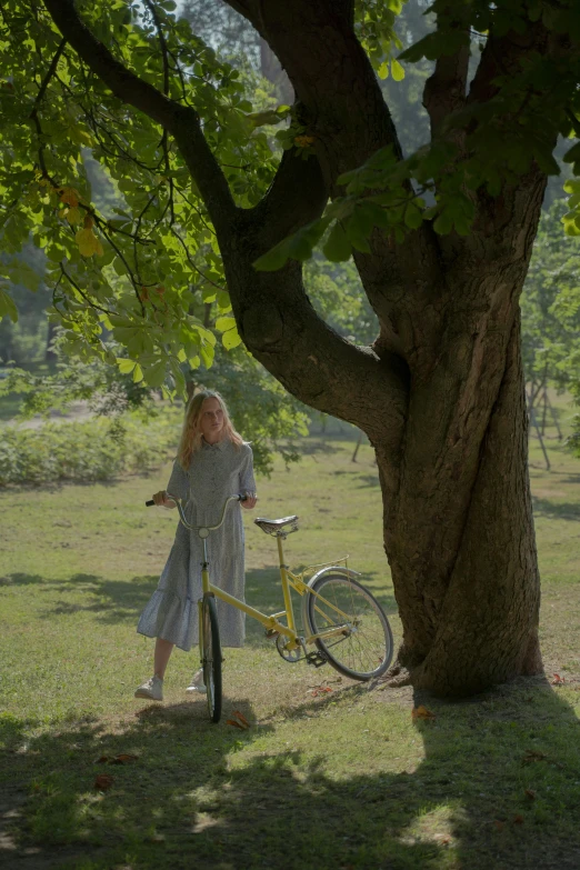 a  standing in a grassy field next to a tree