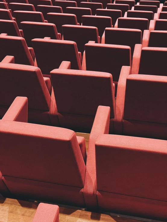 rows of pink seating seats in an auditorium