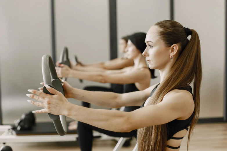 some people doing cardio machines on some kind of board